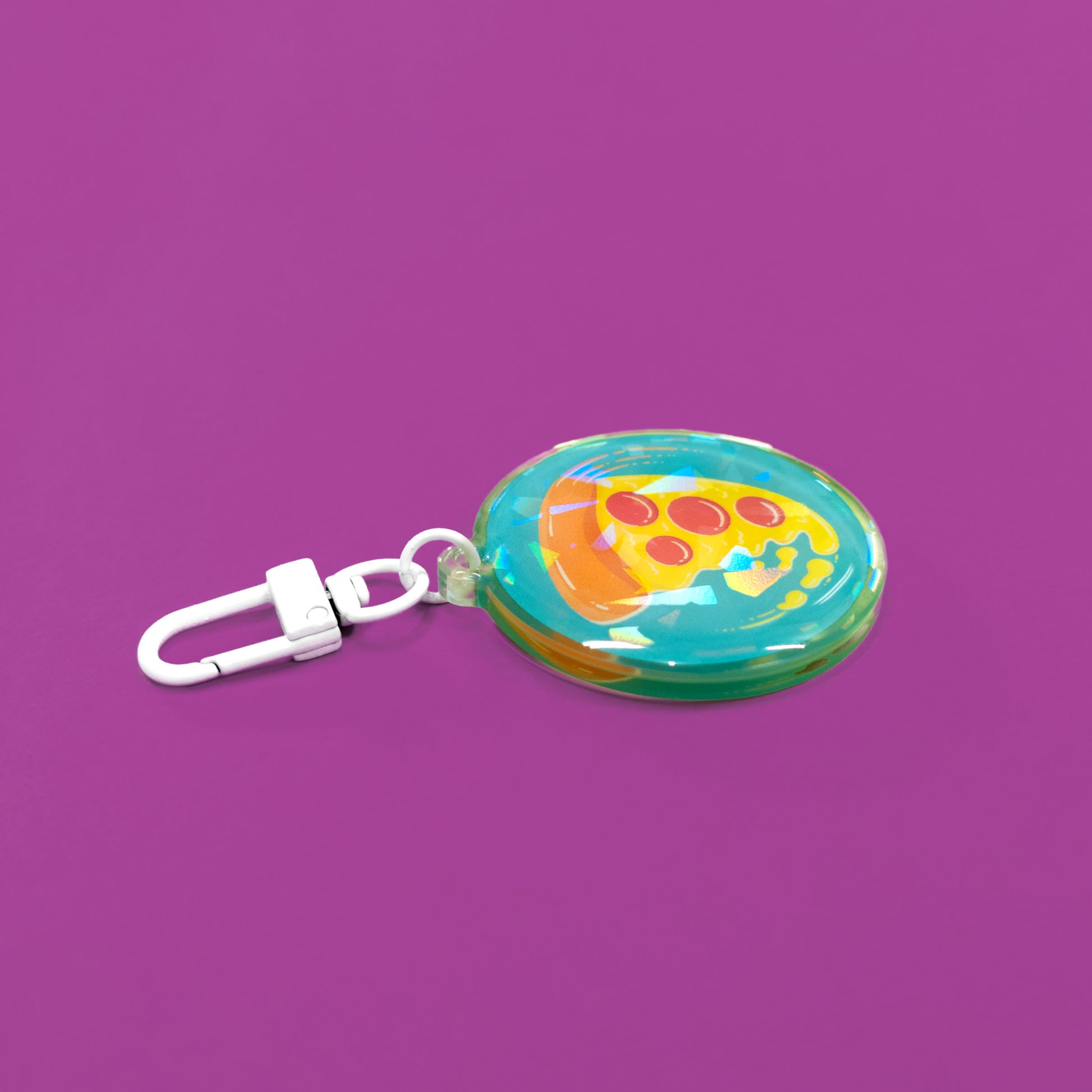 swirling pizza art on a circular holographic keychain